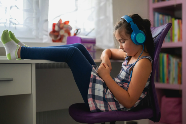 Girl listening to music through headphones