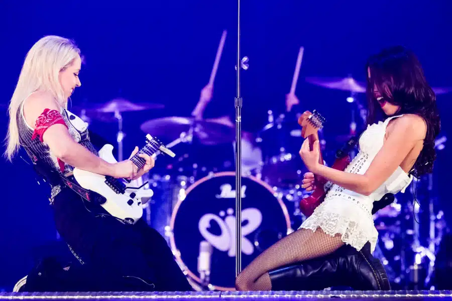Olivia Rodrigo (right) with lead guitarist Arianna Powell — Glastonbury 2025 Photo Credit: Geisler-Fotopress (licensed via Alamy)