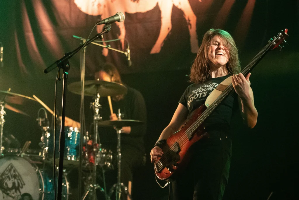 Marie Moe playing bass on stage.
