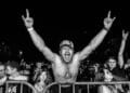 Black & white photo of fan in a rock audience
