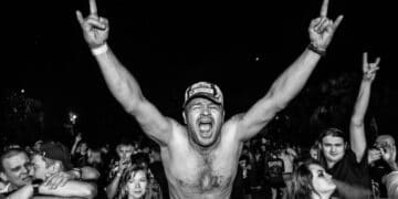 Black & white photo of fan in a rock audience